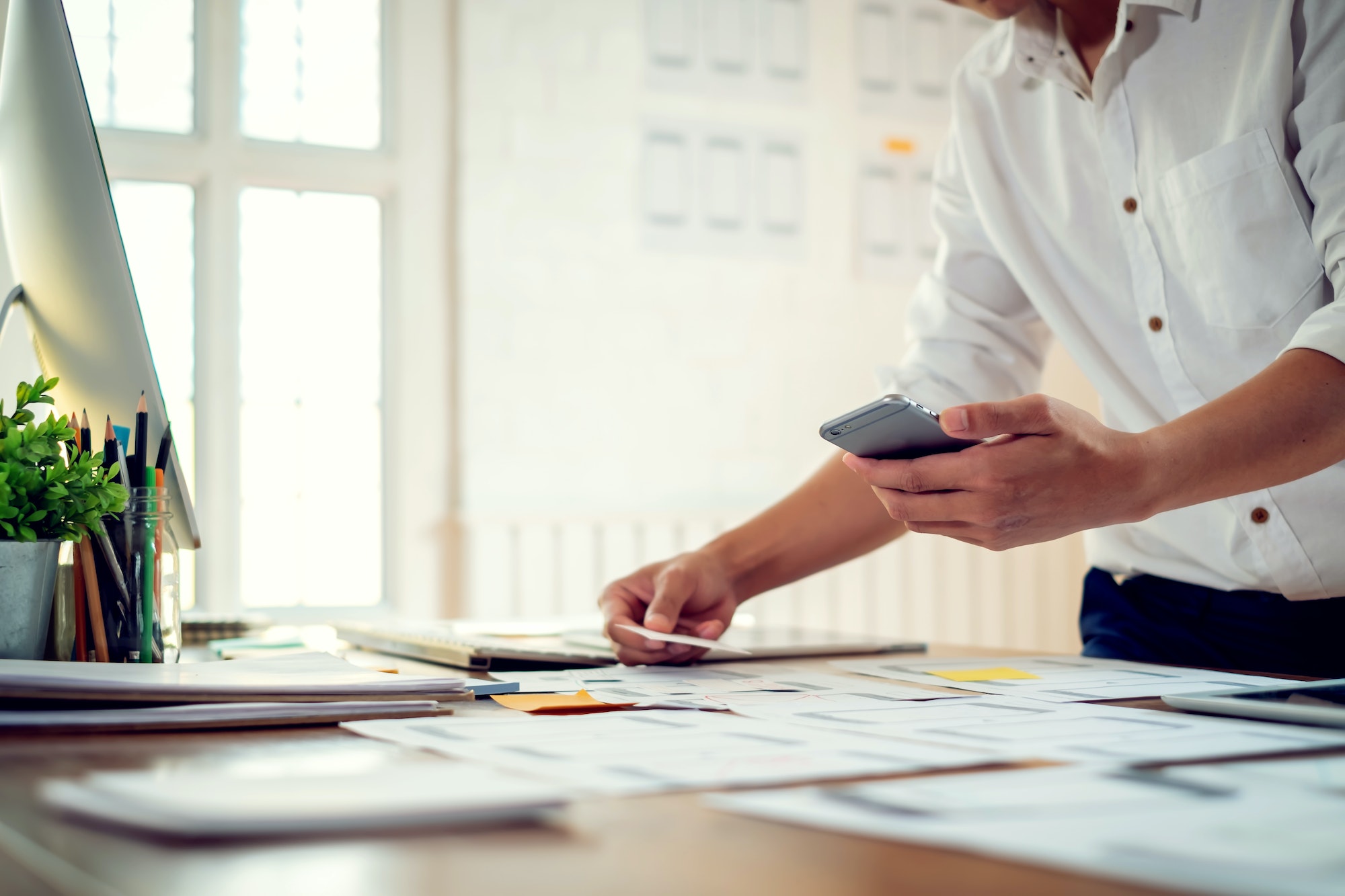 Designer men planning develop application develop for mobile phone.