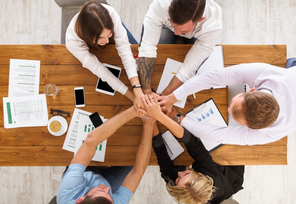 Teamwork and teambuilding concept in office, people connect hand
